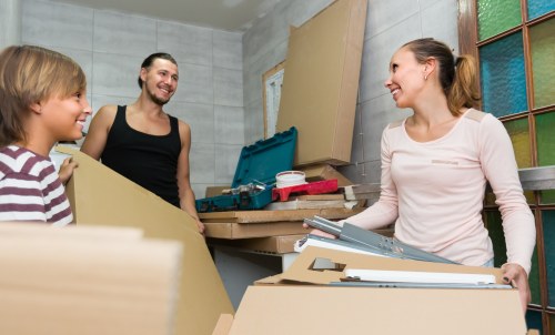 Professional packers wrapping household items in an Edmonton home
