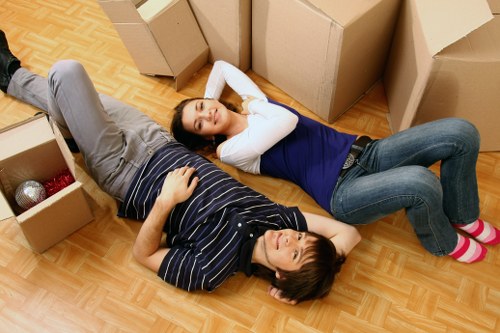 Movers carrying boxes near a condo building in Edmonton